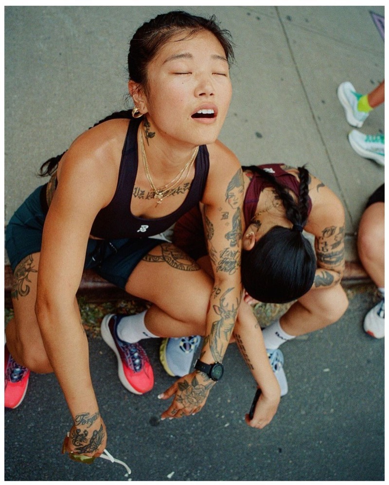 Two runners slumped on a curb, spent after a hard run
