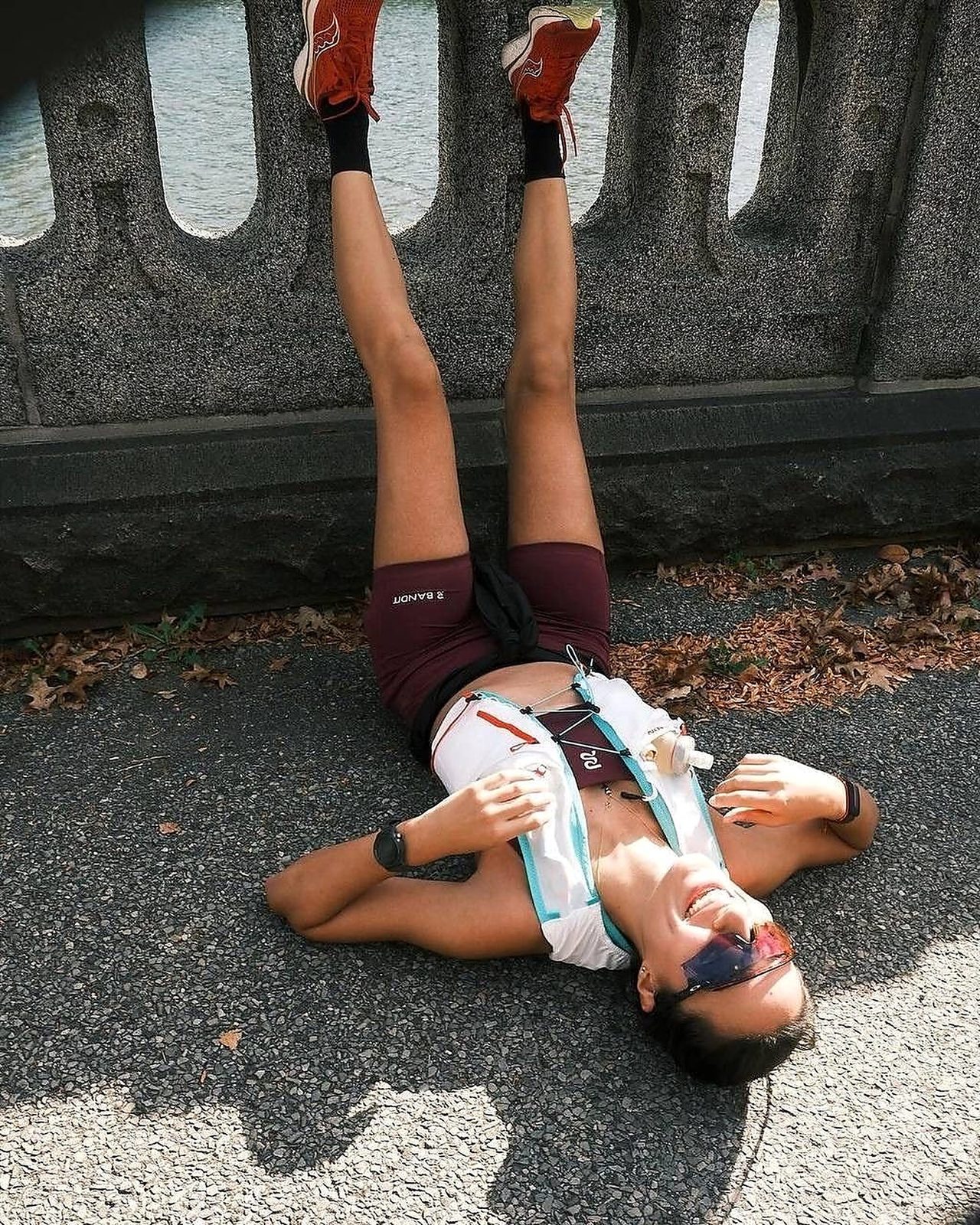 Runner resting after a session, legs up against a wall